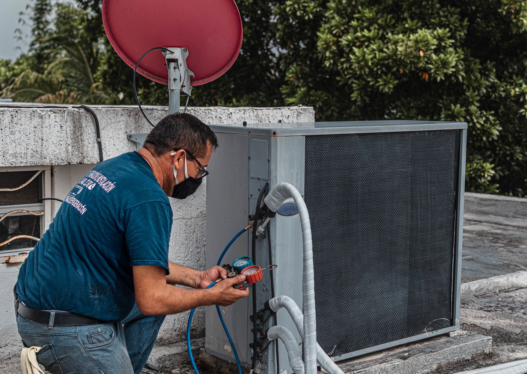 HVAC technician diagnosing an outdoor air conditioning unit